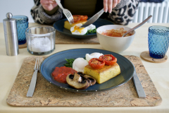 Polenta cake, eggs, roast tomato, spinach and mushroom